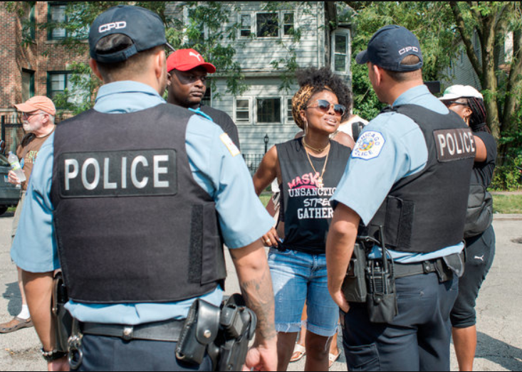 Police-Community Relations: Two police officers speaking to two community members. 